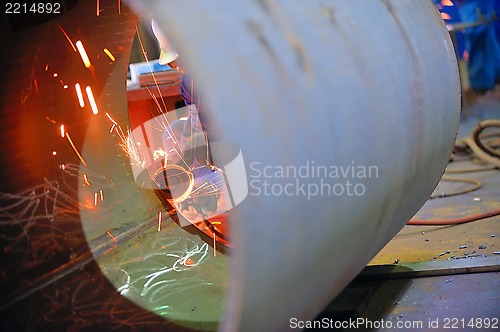 Image of naval welder with protective mask welding metal 