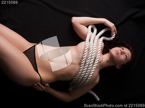 Image of topless woman body covering by rope