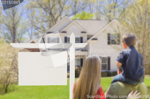 Image of Family in Front of Blank Real Estate Sign and House