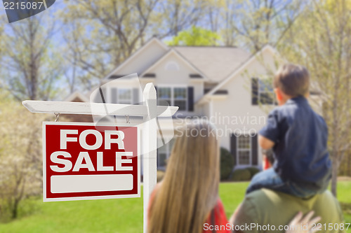Image of Family Facing For Sale Real Estate Sign and House