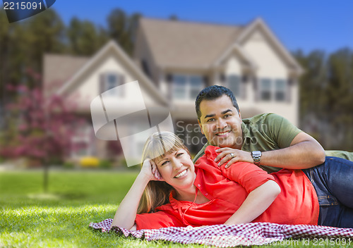 Image of Happy Mixed Race Couple in Front of House