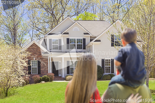 Image of Mixed Race Young Family Looking At Beautiful Home