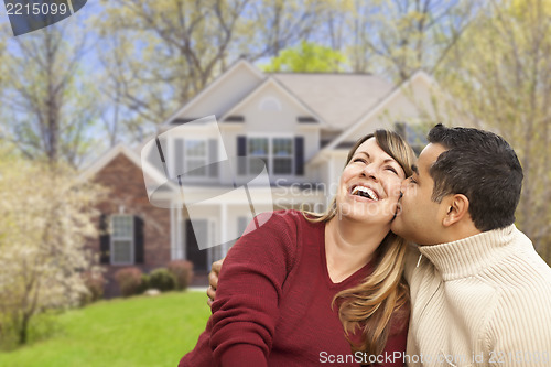 Image of Happy Mixed Race Couple in Front of House