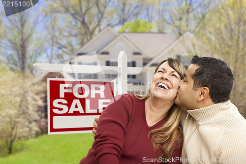 Image of Couple in Front of For Sale Sign and House