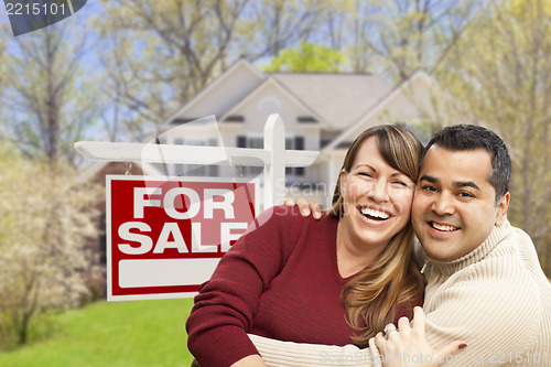 Image of Couple in Front of For Sale Sign and House