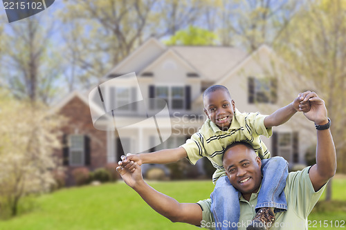 Image of Playful African American Father and Son In Front of Home