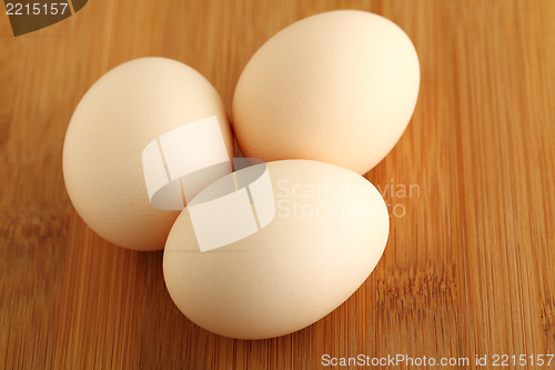 Image of eggs on wooden background