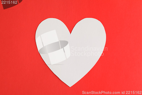 Image of Heart shape paper over red paper background