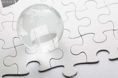 Image of glass globe with puzzle background