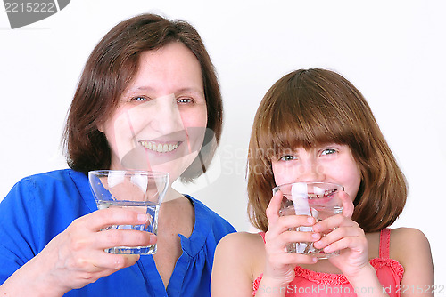 Image of Smiling woman and girl drink water