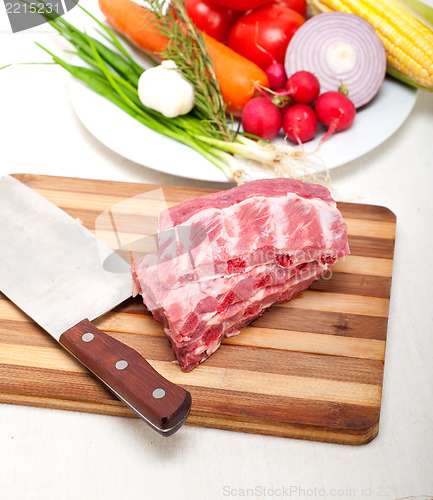 Image of chopping fresh pork ribs and vegetables