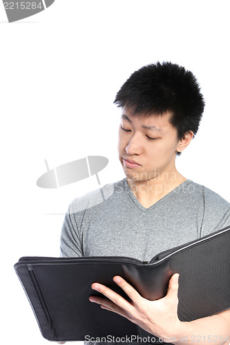 Image of Casual Asian Man Looking Inside Binder