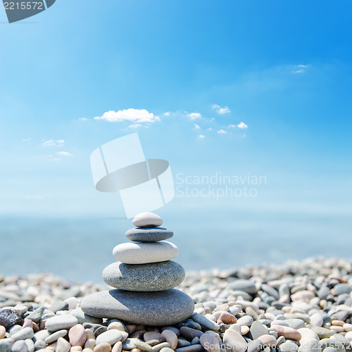 Image of stack of zen stones over sea and clouds background