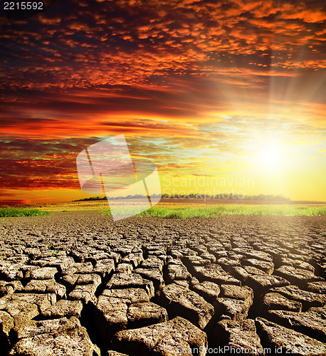 Image of drought earth with red clouds and sunset