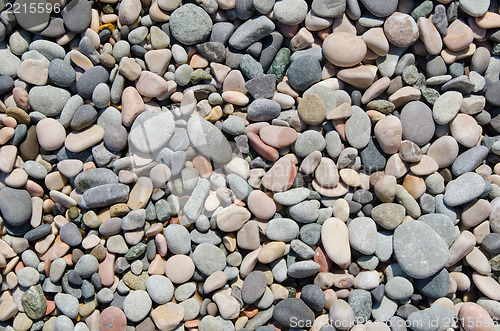 Image of rounded stones on beach as background