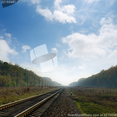 Image of railroad in fog to horizon