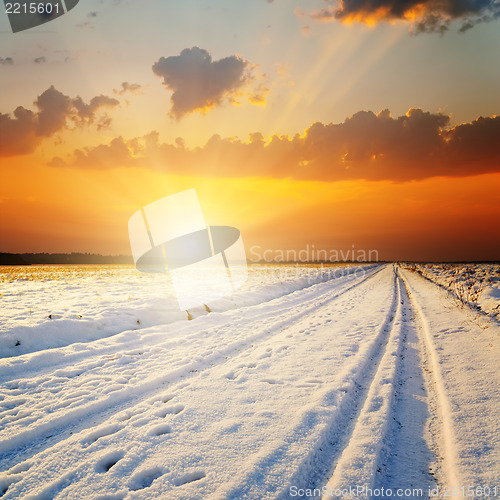 Image of winter landscape. sunset over road with snow