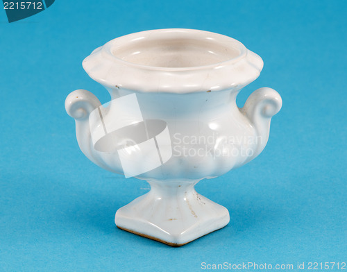 Image of ceramic white small vase dish on blue background 