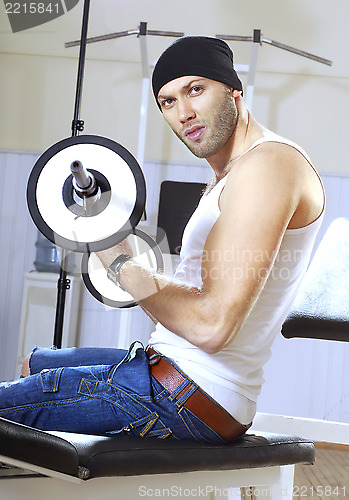 Image of handsome man takes exercises