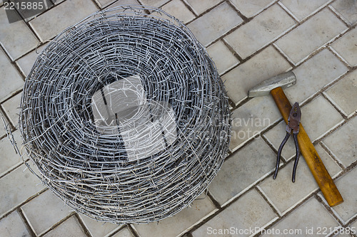 Image of Bay of barbed wire and tool