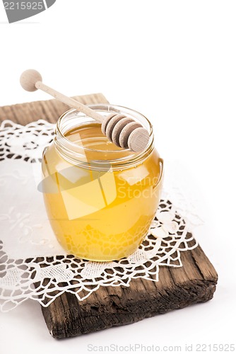 Image of Honey in bank on wooden boards