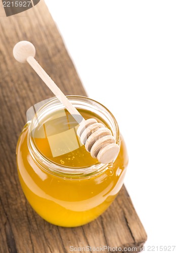 Image of Honey in bank on wooden boards