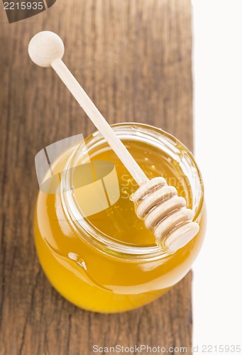 Image of Honey in bank on wooden boards