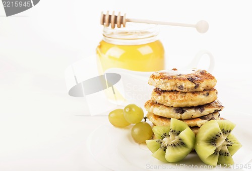 Image of Delightful cheese pancakes with a kiwi and grapes