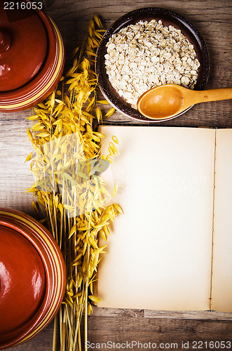 Image of View from the top of an open book of recipes and cooking utensil