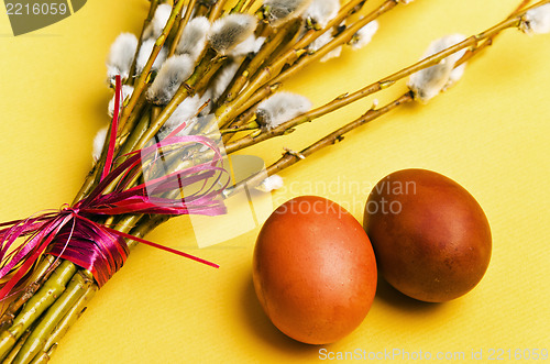 Image of  bunch of willow branches and two Easter eggs 