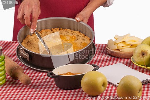 Image of Spreading marmalade on apple pie dough