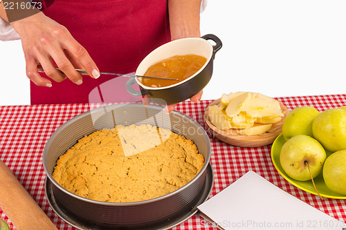 Image of Spreading marmalade on apple pie dough