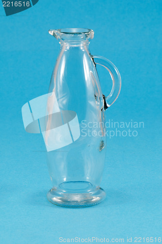 Image of old glass jug jar pitcher handle on blue 