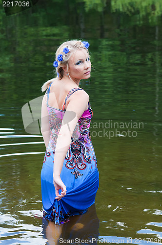 Image of Shot of beautiful woman goes across the pond