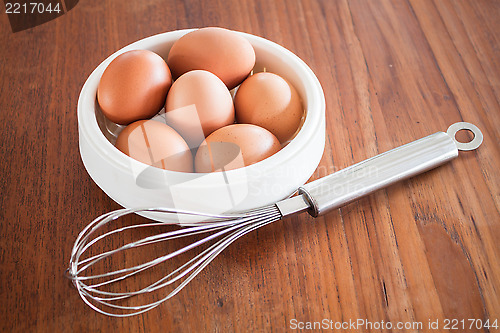 Image of Fresh chicken eggs and hand mixer for beating