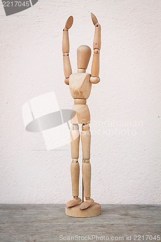 Image of Raising hands up and standing wooden poser 