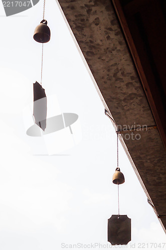 Image of Small wind bell hang on eaves with white background  