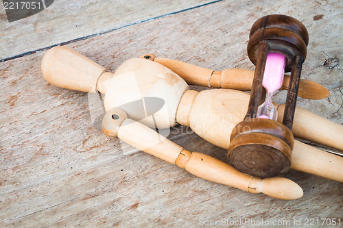 Image of Wood mannequin and hourglass display   time relaxing