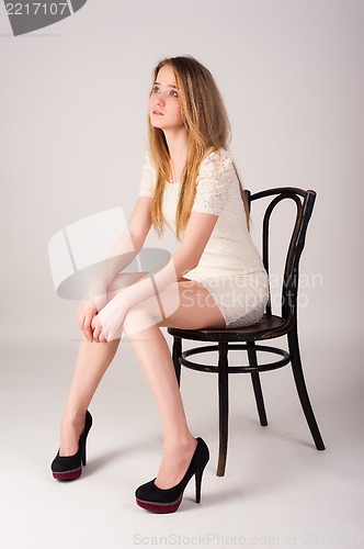 Image of Attractive blonde woman on chair