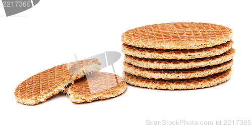 Image of Stroopwafels, Dutch caramel waffles piled up, with one broken in