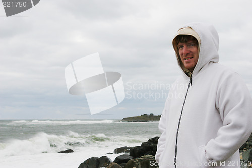 Image of Man at the beach on a cold day