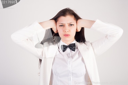 Image of Attractive woman closing her ears