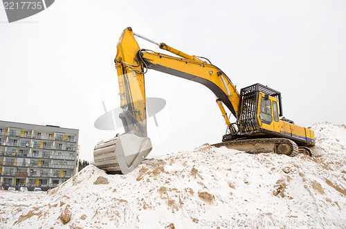 Image of excavator sand pit snow winter apartment house 