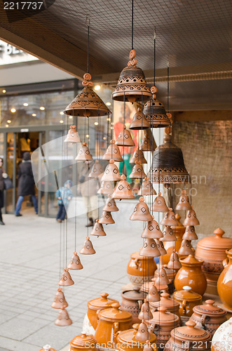 Image of clay pots hang bells ware store shop market people 