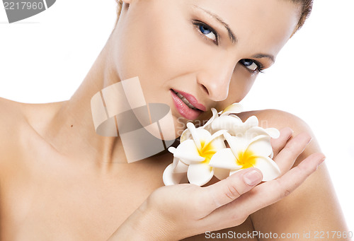 Image of Beautiful woman holding flowers