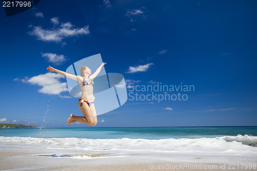 Image of Woman jumping on the beach