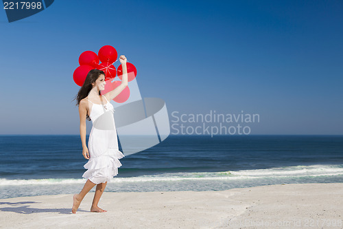 Image of Beautiful girl holding red ballons