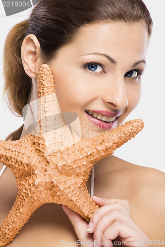 Image of Beautiful woman holding a starfish