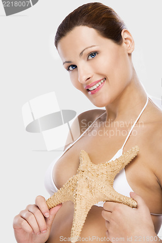 Image of Beautiful woman holding a starfish