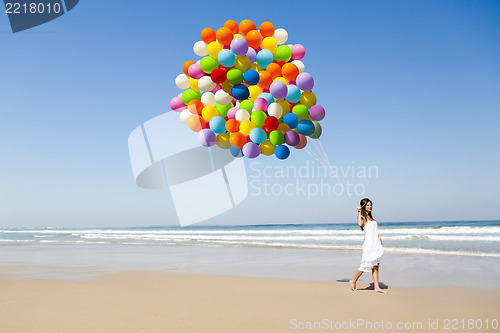 Image of Beauty walking with ballons